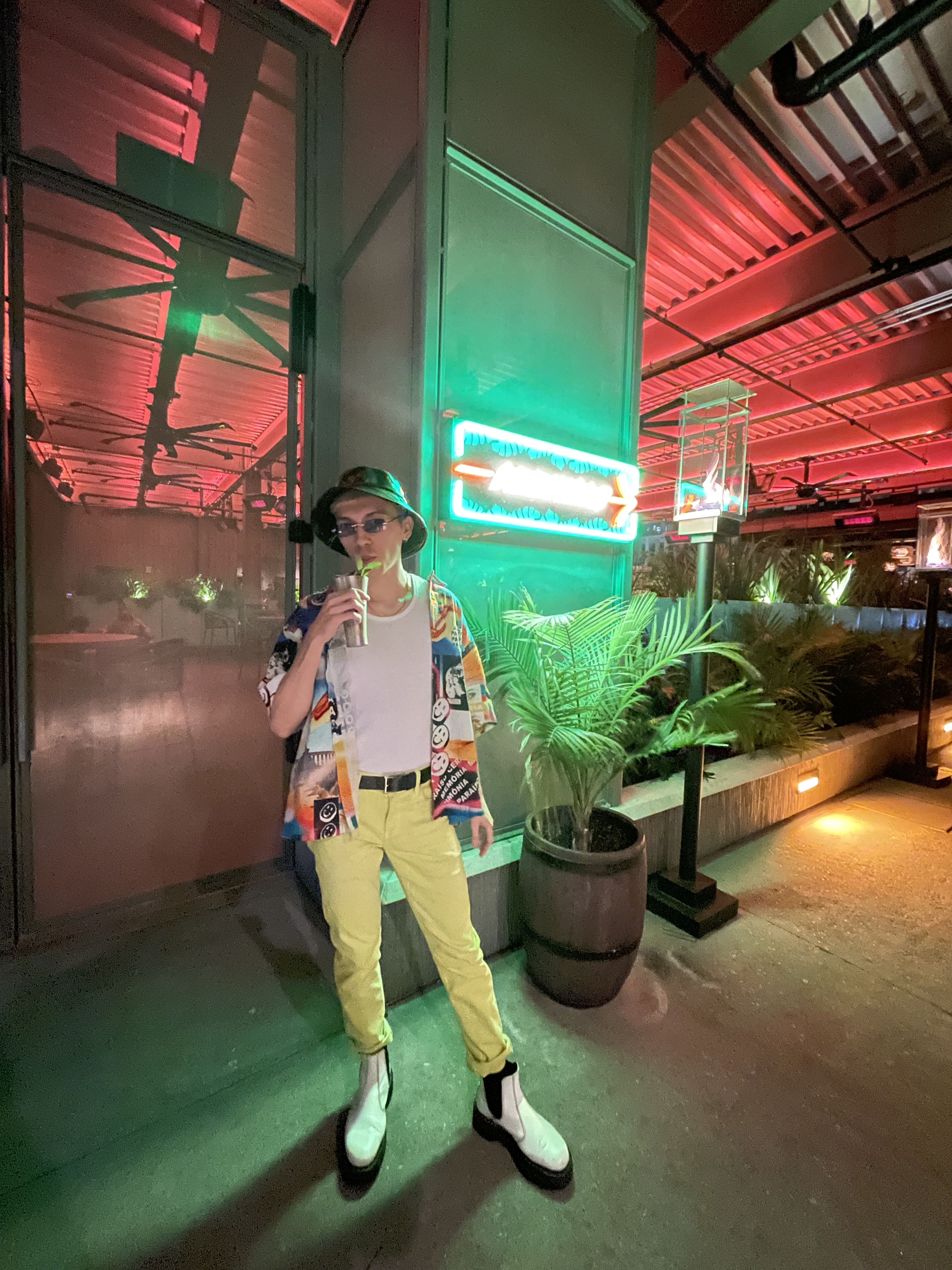 Stephen wearing ravey fit with neon green jeans and black vinyl bucket hat